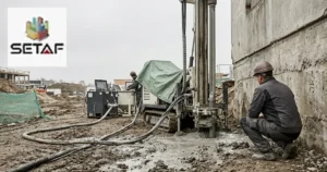 Jet Grouting: a drill rig forming a column on a construction site with high-pressure grout lines and spoil returning at the collar